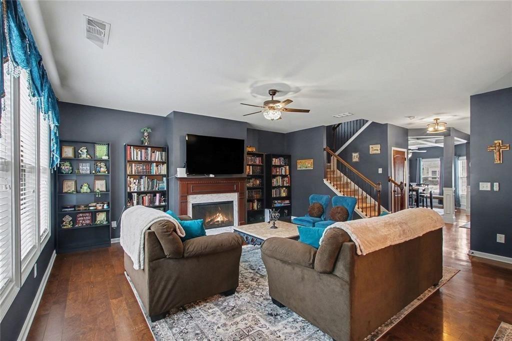 3499 In Bloom Way Auburn, GA 30011 - Photo 4 of 30 a living room with furniture a fireplace and a flat screen tv