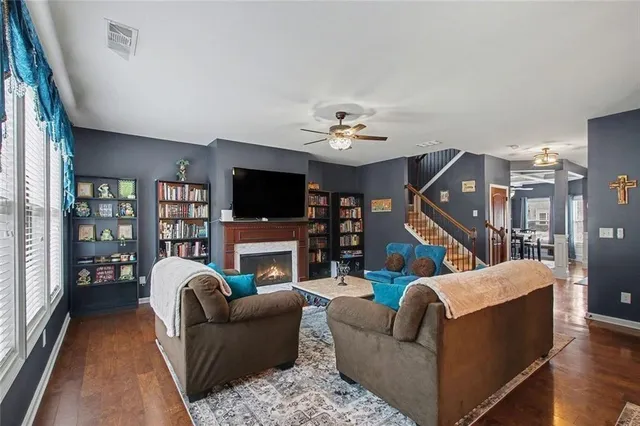 a living room with furniture ceiling fan and a window