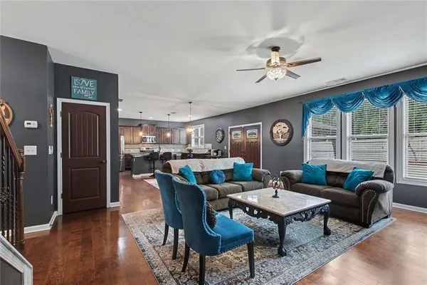 a living room with furniture a fireplace and a flat screen tv