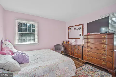 a bedroom with a bed and flat screen tv