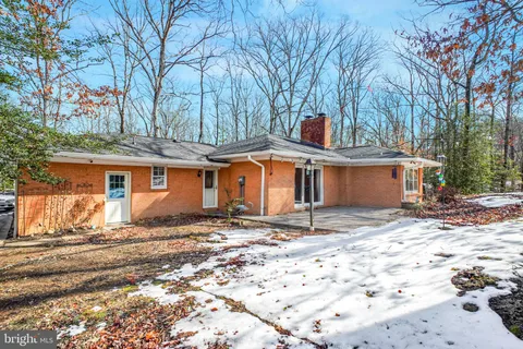 a backyard of a house with large trees