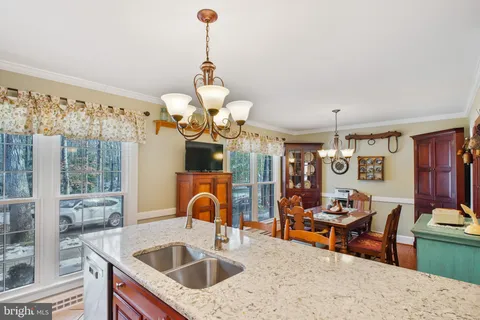 a kitchen with a table chairs and living room