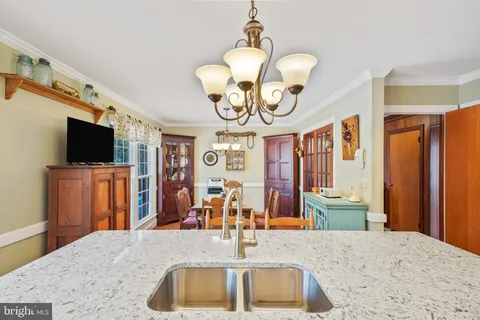 a view of kitchen with sink microwave and refrigerator