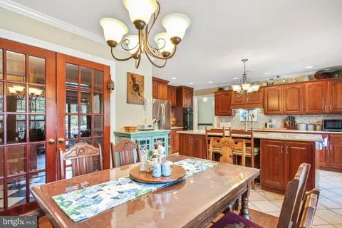 a kitchen with a dining table and chairs