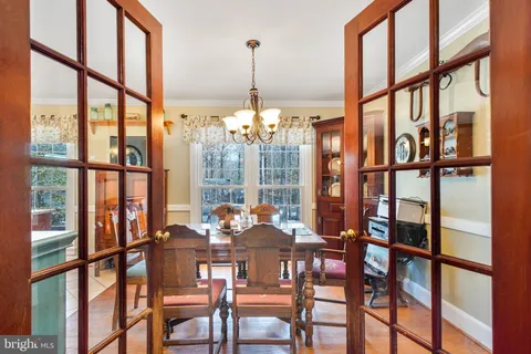 a view of a dining room with furniture large windows and plants
