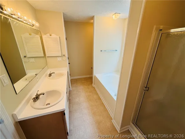 a bathroom with a sink a mirror and shower