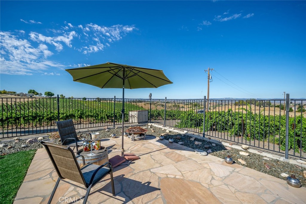 6172 Hawk Ridge Place San Miguel, CA 93451 - Photo 16 of 74 a view of a chairs and table under an umbrella in backyard