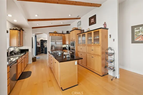 a bathroom with a granite countertop sink and a large mirror