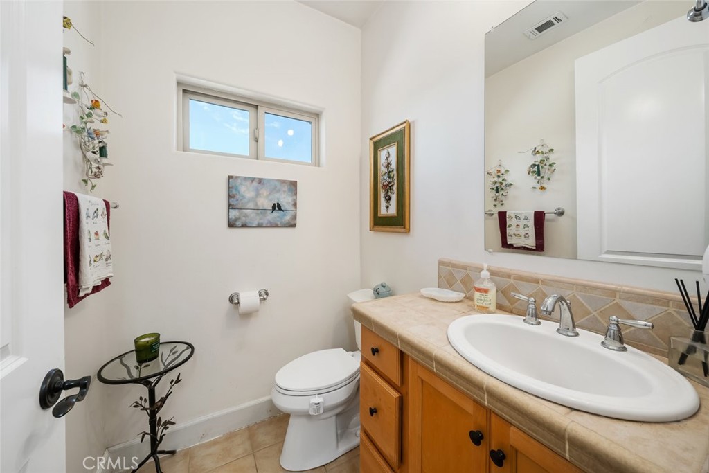 6172 Hawk Ridge Place San Miguel, CA 93451 - Photo 56 of 74 a bathroom with a granite countertop sink mirror and toilet