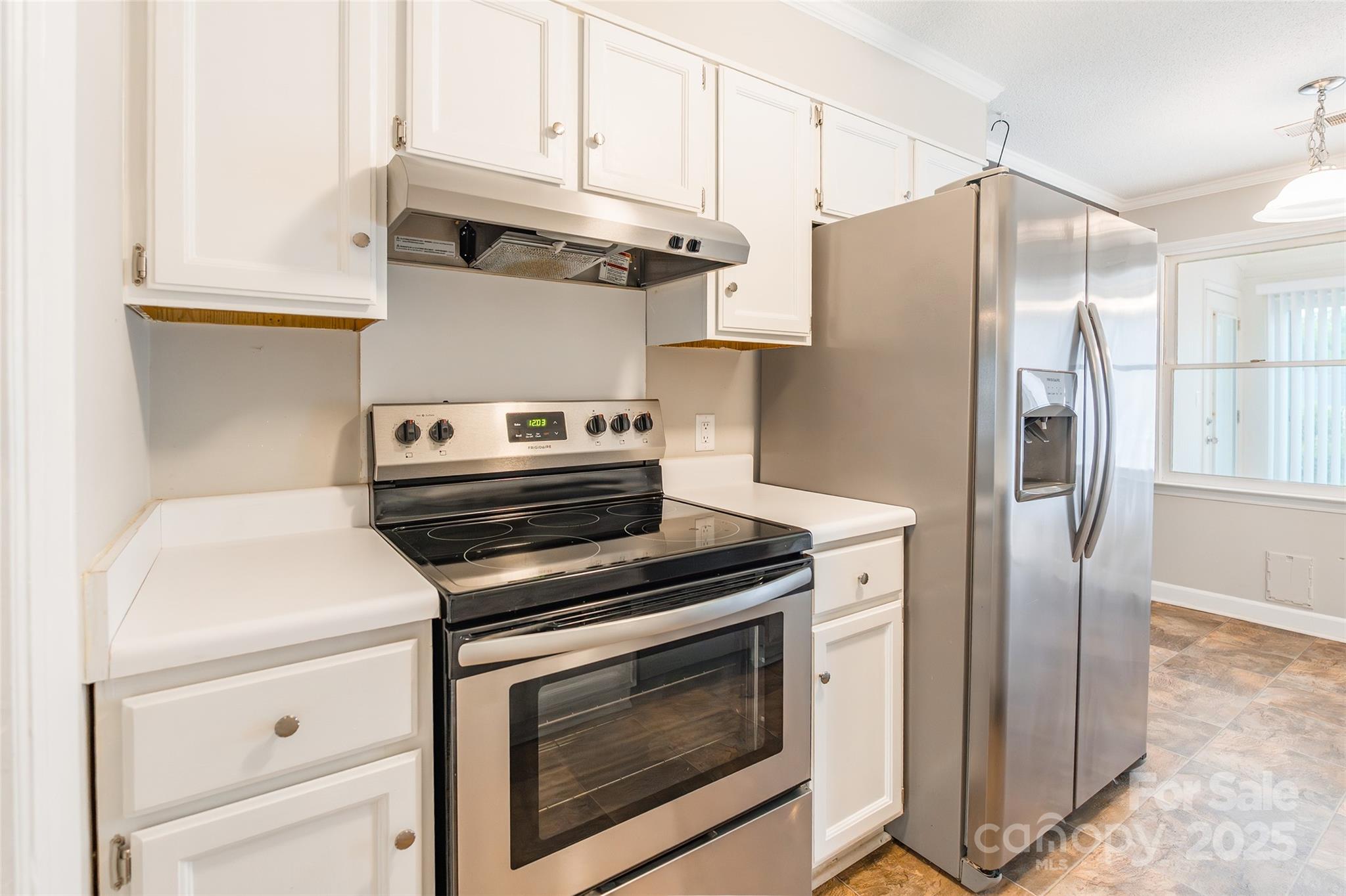 1806 Ebenezer Road, Unit E Rock Hill, SC 29732 - Photo 8 of 23 a kitchen with stainless steel appliances white cabinets and a stove