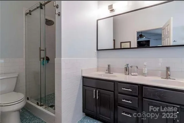 a bathroom with a toilet a sink and mirror