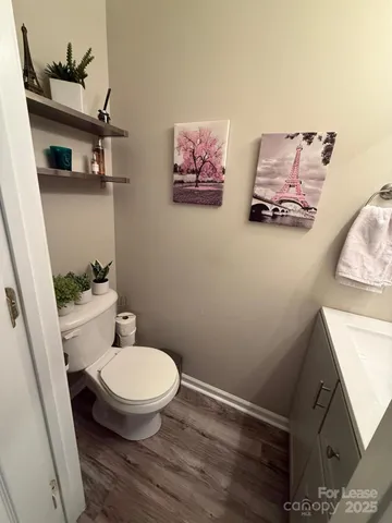 a room with hard wood and a mirror