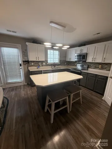 a view of a room with a table and chairs