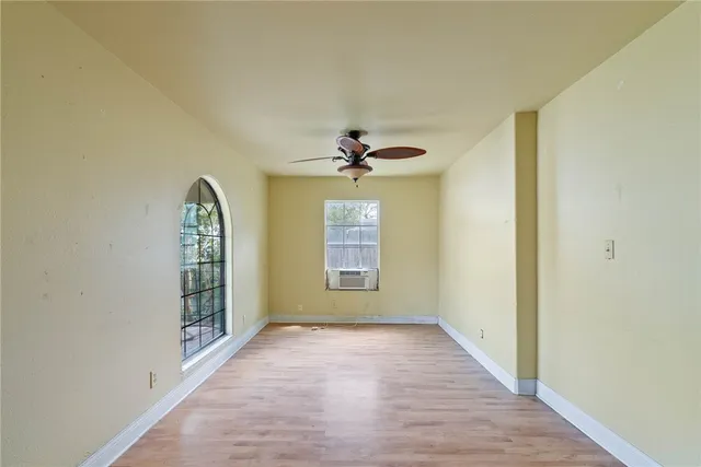 wooden floor in an empty room with a window