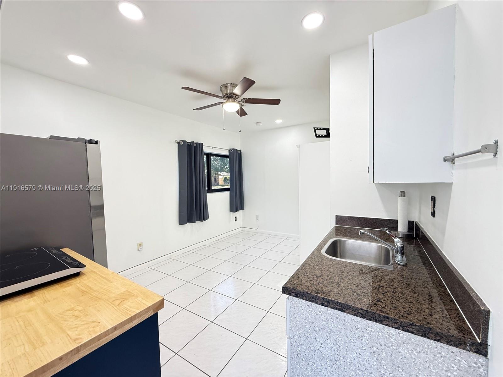 7680 Southwest 134th Court, Unit B Miami, FL 33183 - Photo 2 of 7 a kitchen with stainless steel appliances granite countertop a sink stove and refrigerator