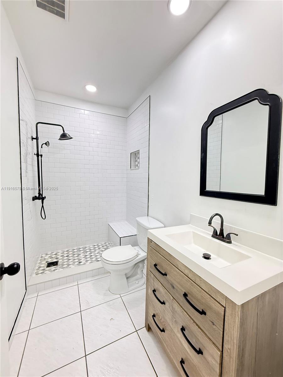 7680 Southwest 134th Court, Unit B Miami, FL 33183 - Photo 6 of 7 a bathroom with a sink a toilet and mirror