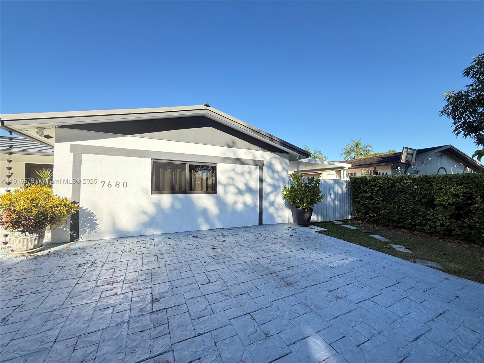 7680 Southwest 134th Court, Unit B Miami, FL 33183 - Photo 7 of 7 a view of house with backyard