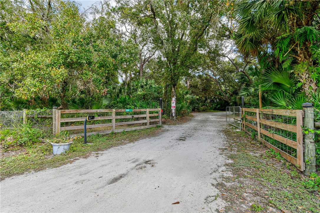 a view of a yard with wooden fence