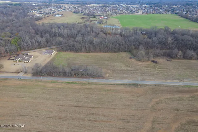 a view of a swimming pool and a yard