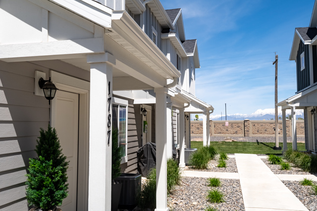 1787 North 1280 East Payson, UT 84651 - Photo 21 of 22 Gray siding exterior with white trim, featuring a covered entryway with a decorative sconce