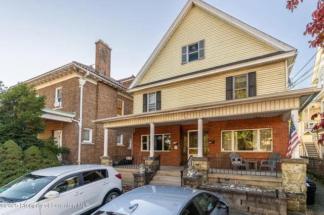 a front view of a house with outdoor seating