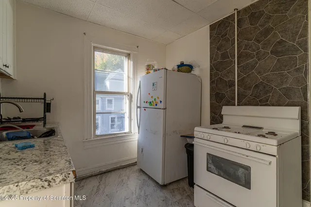 a utility room with faucet washer and dryer
