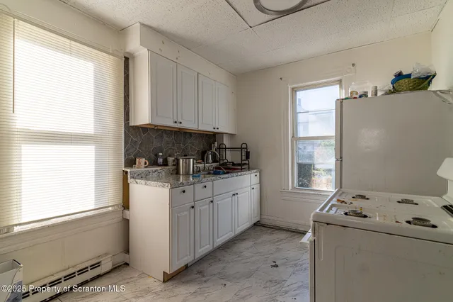 a bathroom with a sink and mirror with bathtub