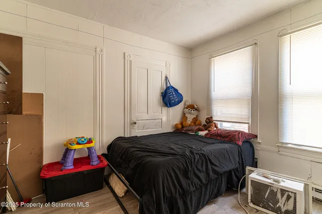 a bedroom with a bed and flat screen tv