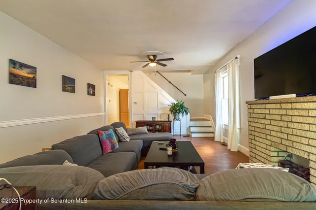 a living room with furniture and wooden floor