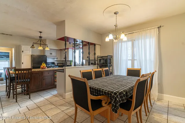 a kitchen with a refrigerator a sink and a window