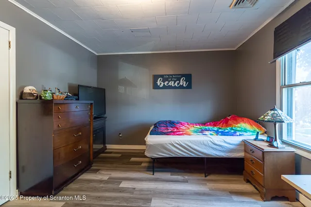 a bedroom with furniture and a window