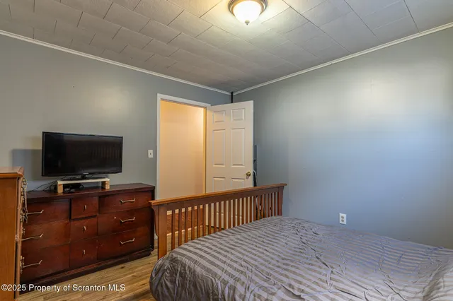 a bed sitting in a spacious bedroom next to a window