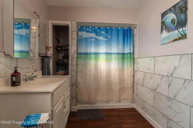 a bathroom with a sink mirror vanity and bathtub