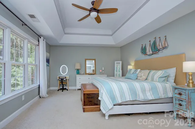 a bedroom with a bed lamp and a window