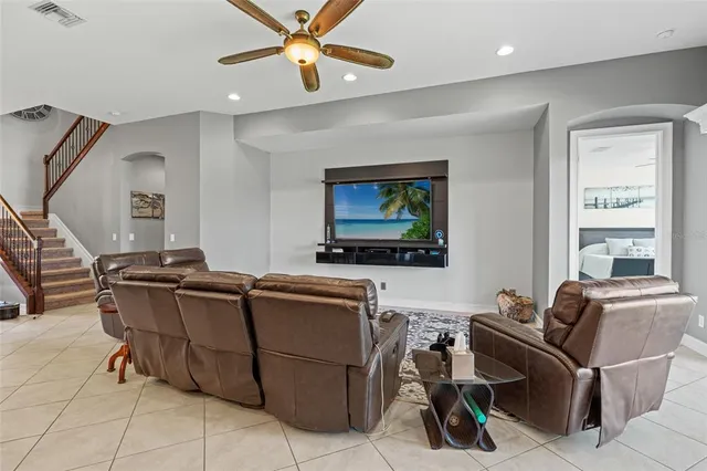 a kitchen with granite countertop a stove a sink a dining table and chairs