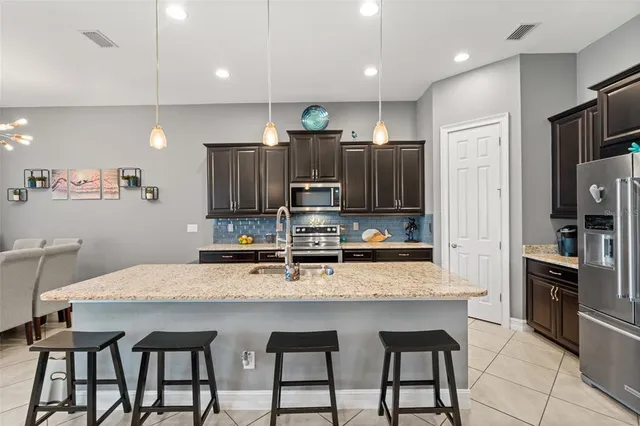 a kitchen with stainless steel appliances granite countertop a sink and counter space