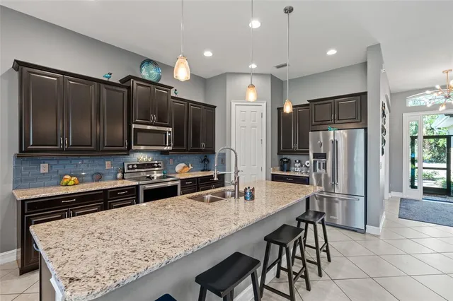 a view of a dining room with furniture and chandelier