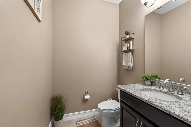 a spacious bedroom with a bed and a ceiling fan