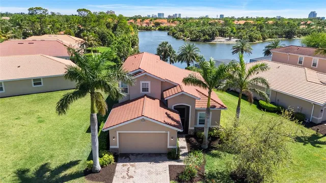 an aerial view of a house with outdoor space and lake view