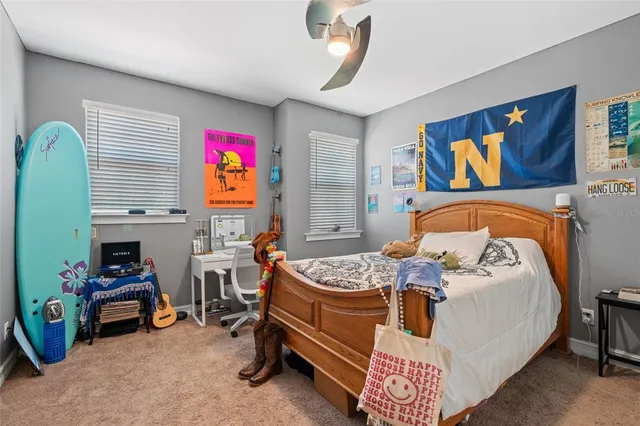 a living room with patio furniture and a floor to ceiling window