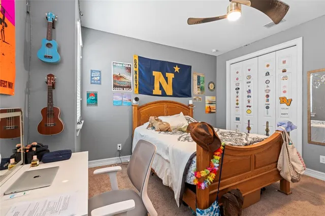 a view of a livingroom with furniture and a ceiling fan