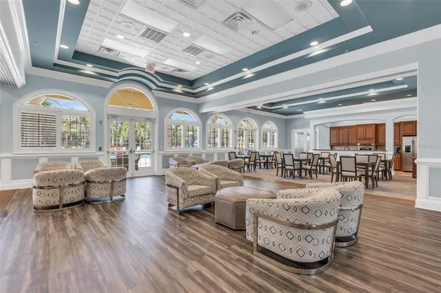 an aerial view of residential houses with outdoor space and trees