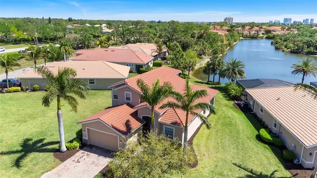 an aerial view of residential houses with outdoor space and swimming pool