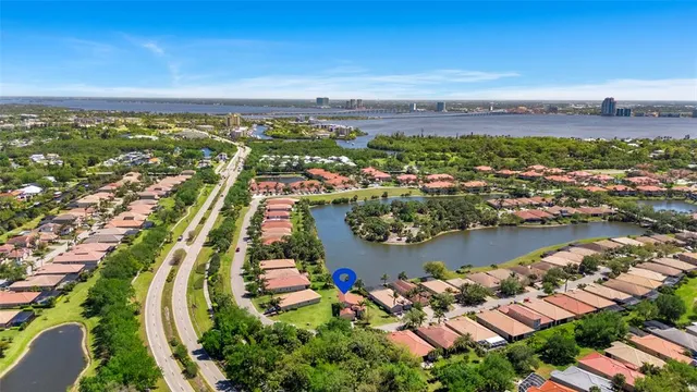 an aerial view of a city with lots of residential buildings lake and ocean view