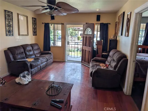a living room with furniture and wooden floor