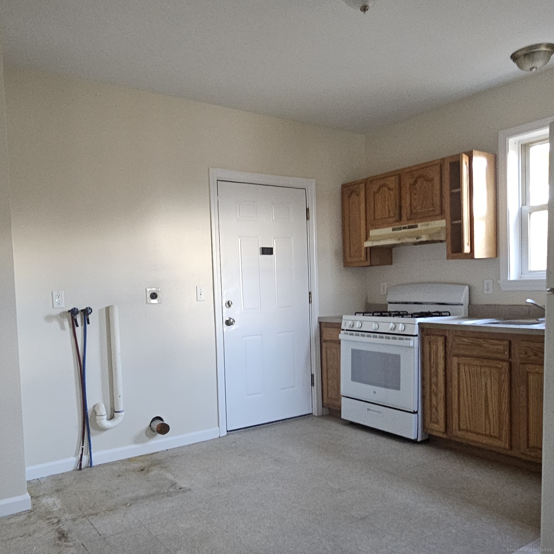 35 Lawrence Street Waterbury, CT 06708 - Photo 2 of 11 a kitchen with granite countertop white cabinets and white appliances