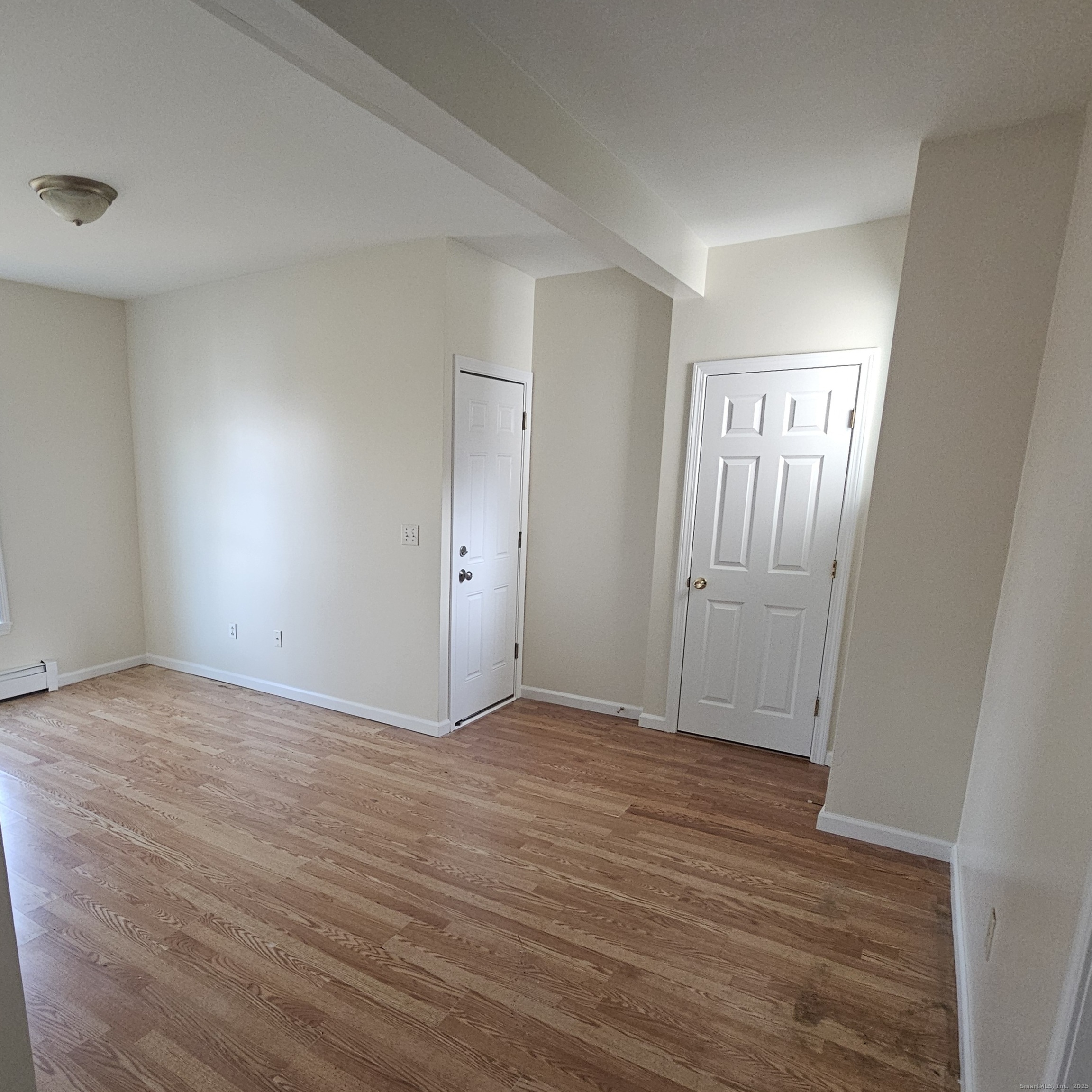 35 Lawrence Street Waterbury, CT 06708 - Photo 4 of 11 a view of an empty room and wooden floor