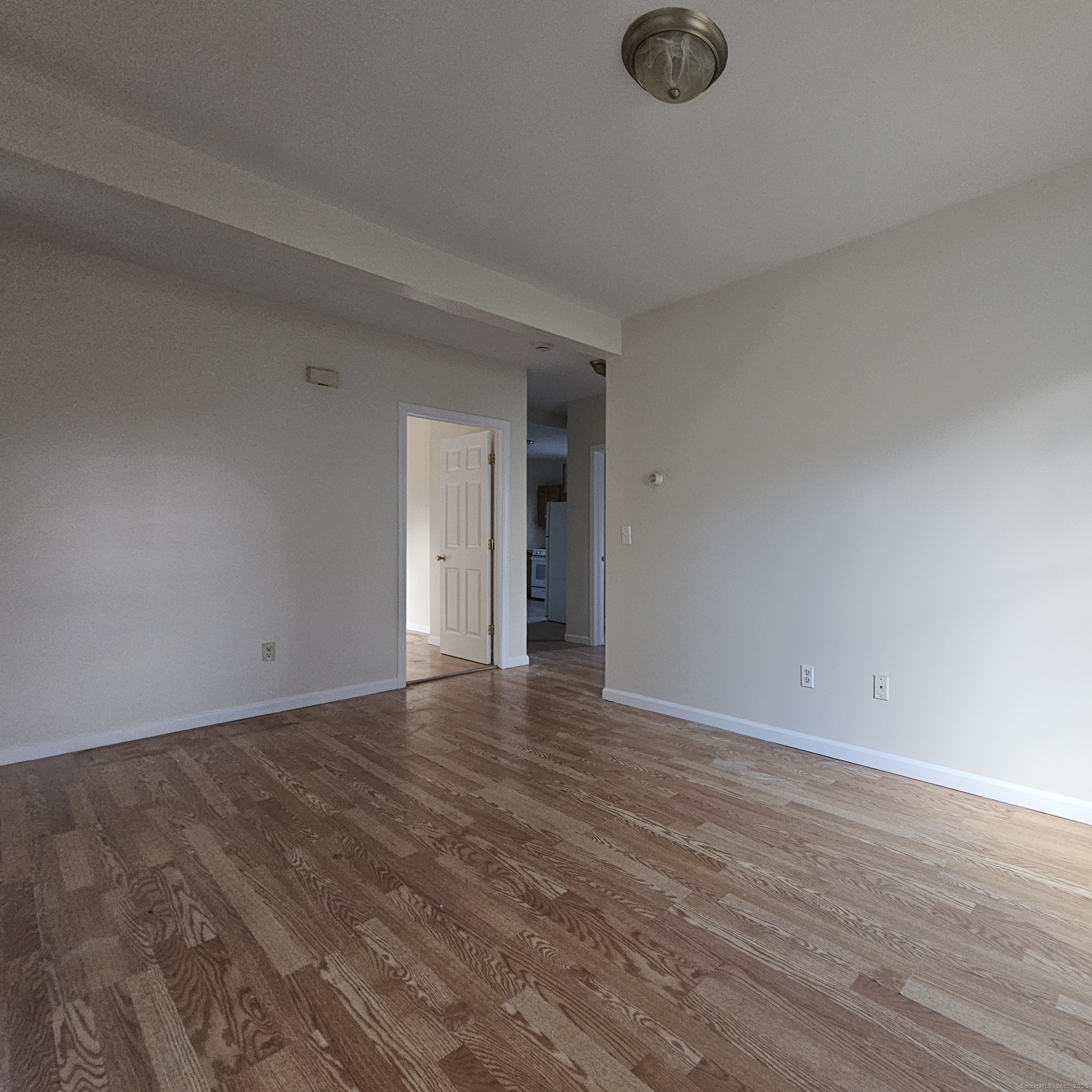 35 Lawrence Street Waterbury, CT 06708 - Photo 5 of 11 a view of an empty room with wooden floor and a window
