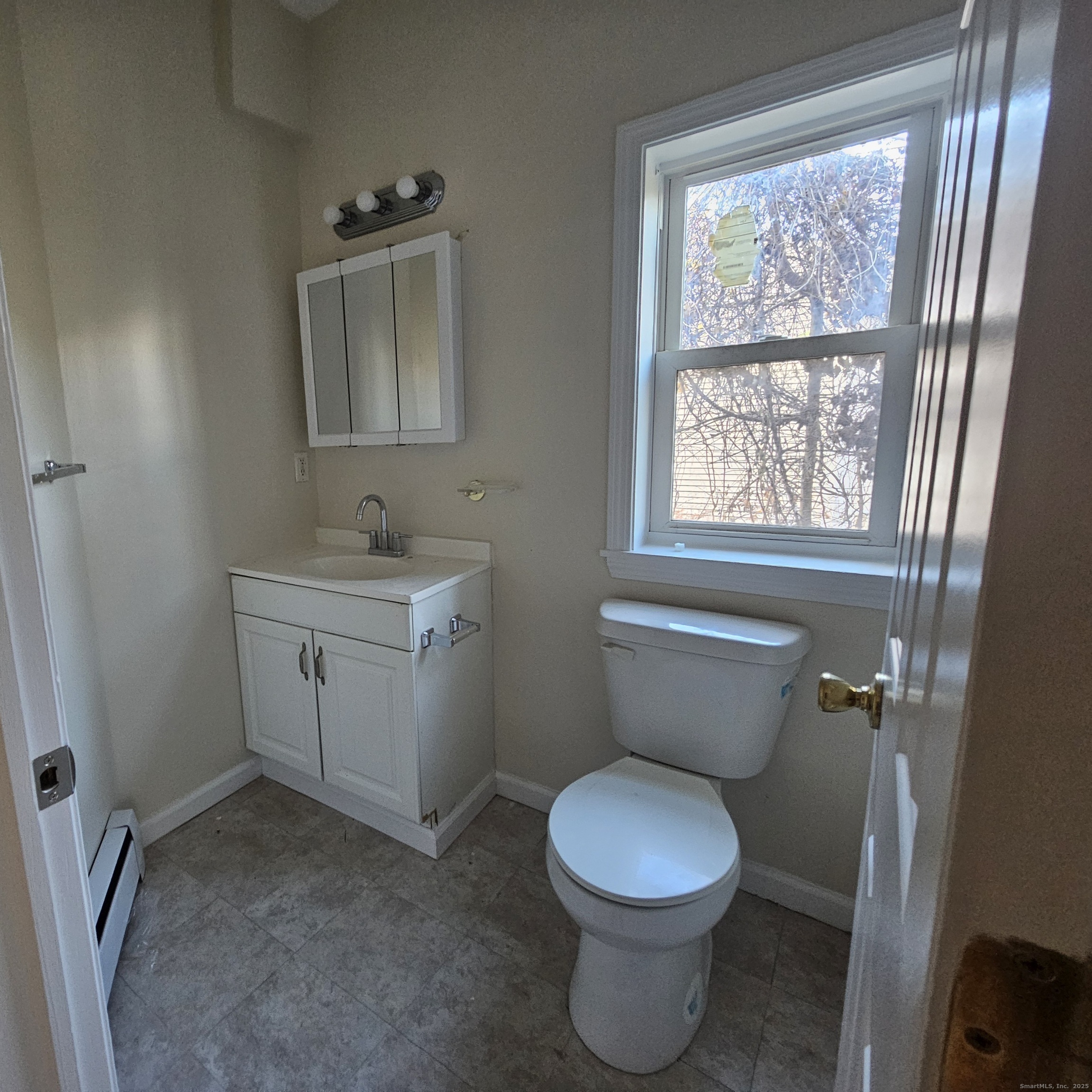 35 Lawrence Street Waterbury, CT 06708 - Photo 6 of 11 a bathroom with a toilet sink and mirror