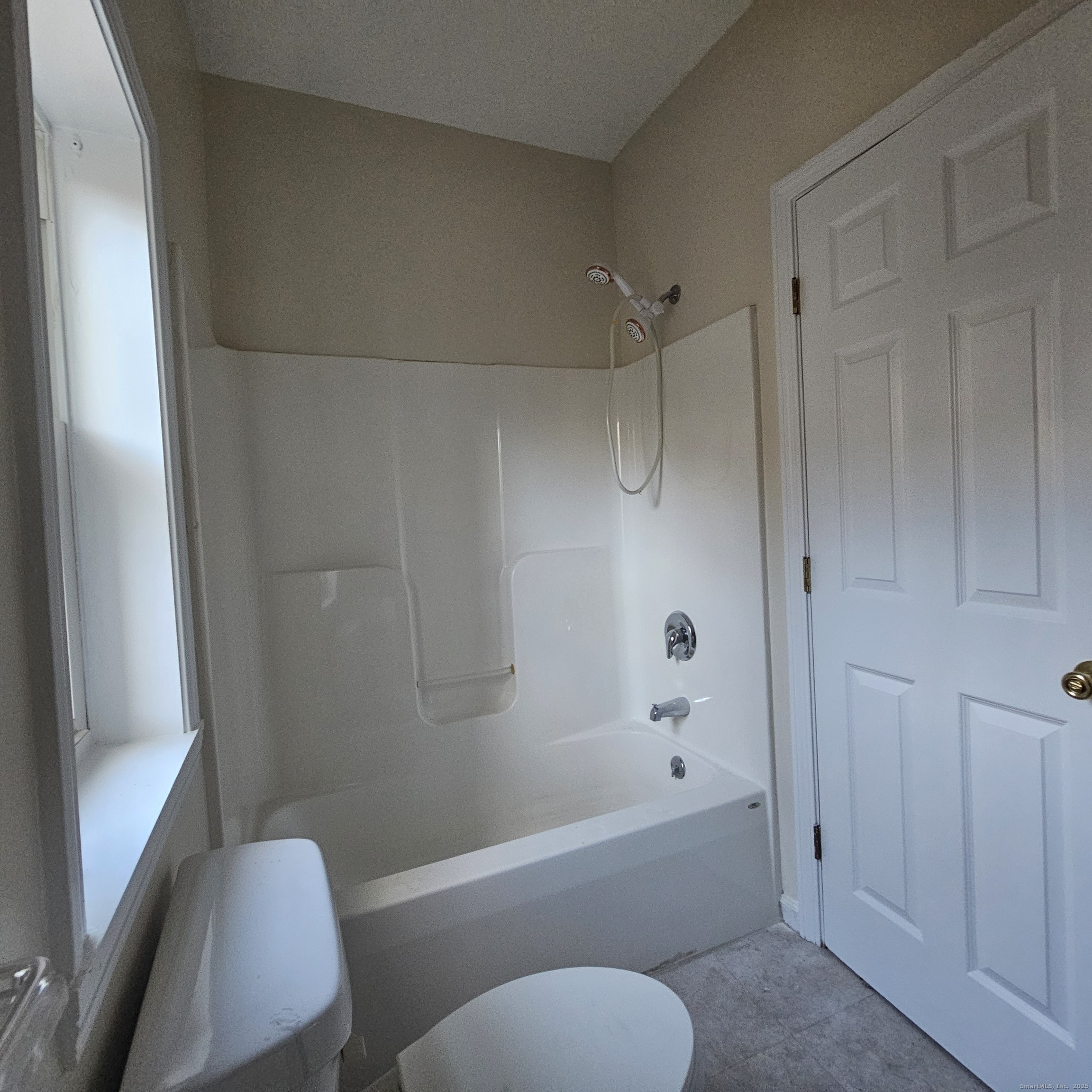 35 Lawrence Street Waterbury, CT 06708 - Photo 7 of 11 a bathroom with a toilet and a bathtub